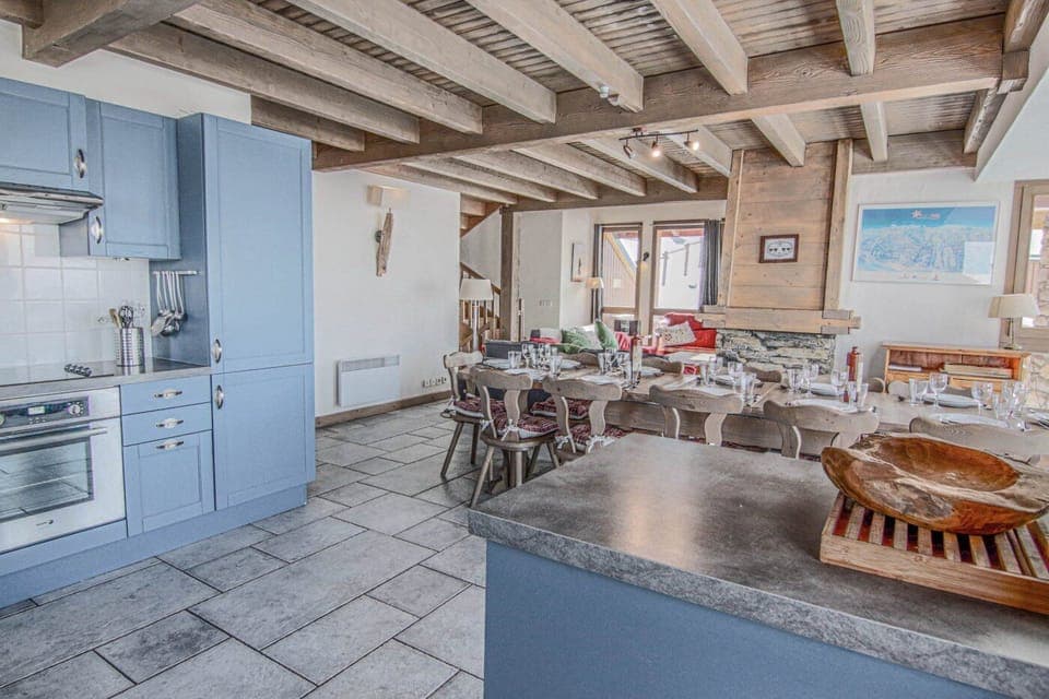 Large open plan living and dining area with views over the piste with floor to ceiling windows.