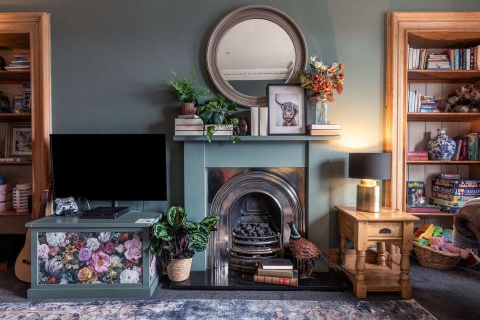 Cosy Living Room with comfortable seating, smart TV with Sky, PlayStation, games, toys and books