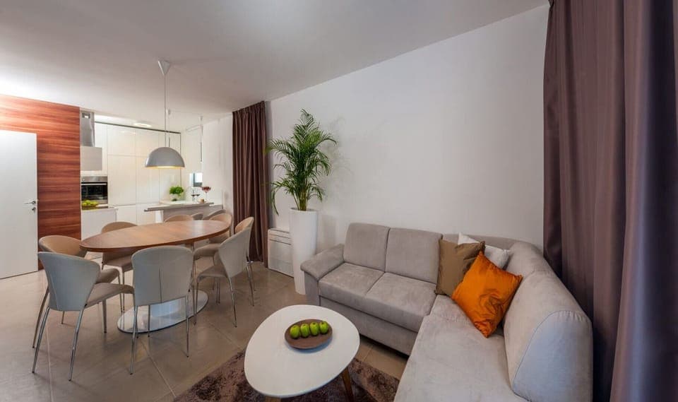 Living room with a  sofa, dining area and a fully equipped kitchen on the ground floor of a Croatia luxury modern villa  Trogir 1 with pool