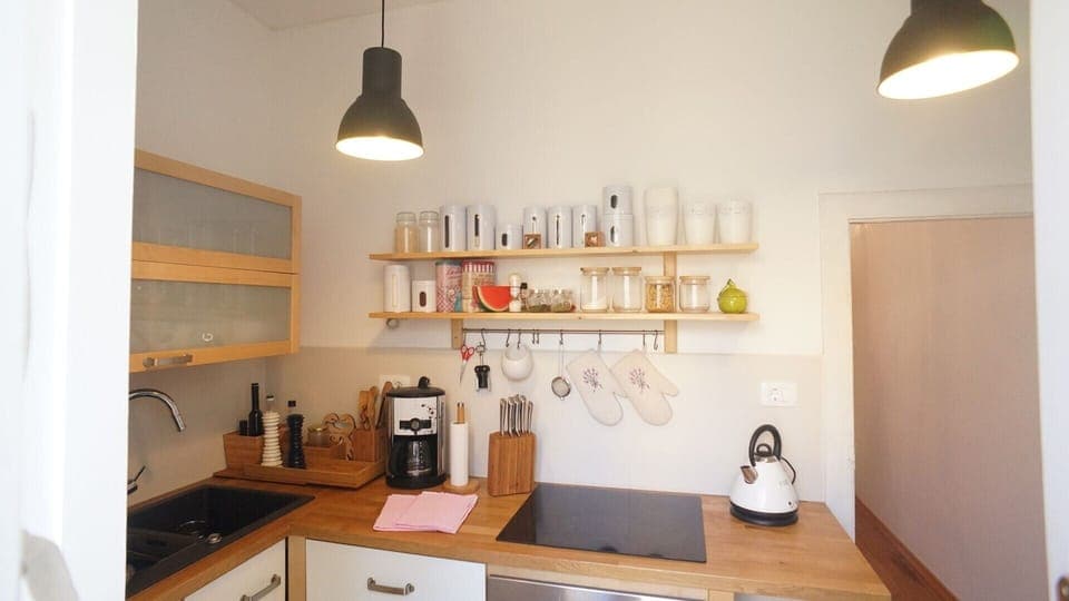 Wooden kitchen on the ground floor of rental villa in Orebić equipped with oven, coffee maker, kettle