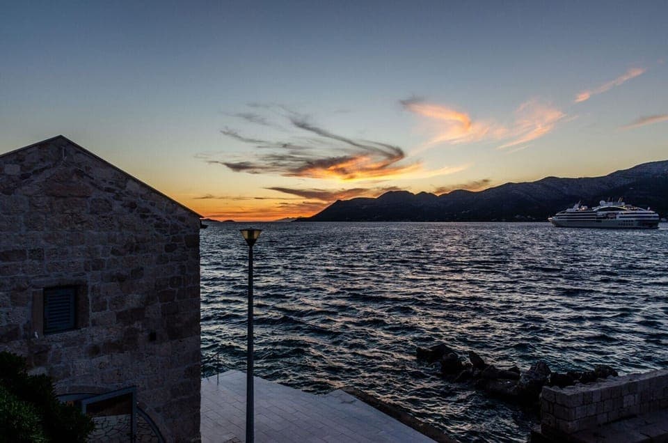 A view of the beautiful sunset in the Mediterranean environment from the property of the luxurious vacation villa Gabriela by the pebble beach