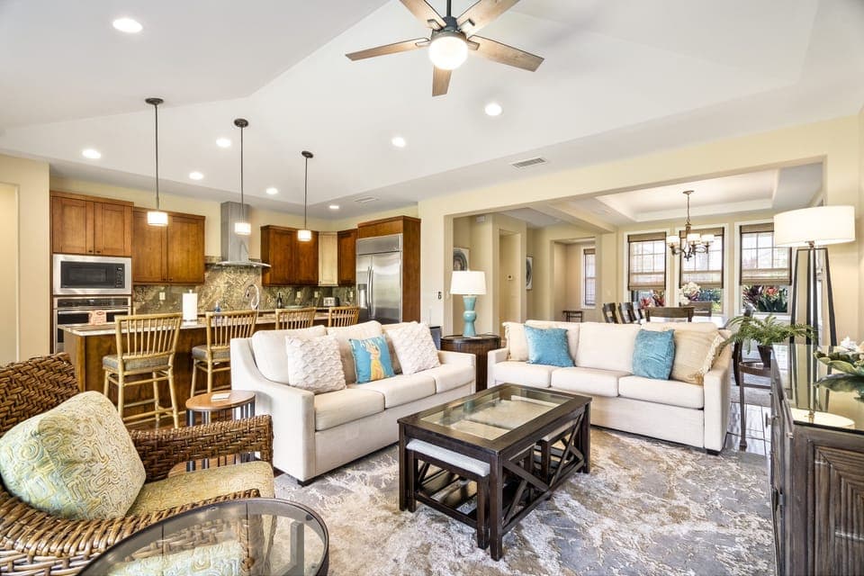 The living area of this Holua Kai at Keauhou rental, with two couches and a glass-topped coffee table.