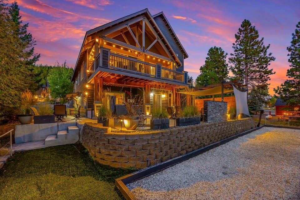 Grand Mountain Lodge With Glowing Timber Facade And Signature Peak Roofline