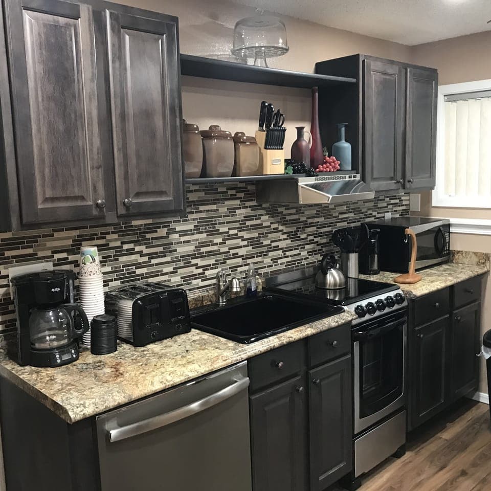 Kitchen is stocked with cookware and utensils to make a complete meal.