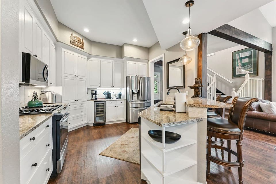 Kitchen: Stainless steel appliances, gas range, granite countertops, wine cooler, 2-person bar seating
