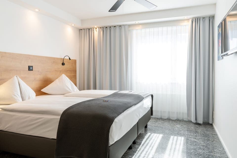 Double Room Single Use | Living area | Flat-screen TV