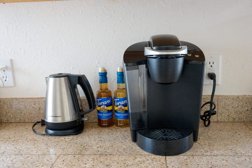 Keurig and hot pot, full coffee pot, filters and coffee grounds stocked too.