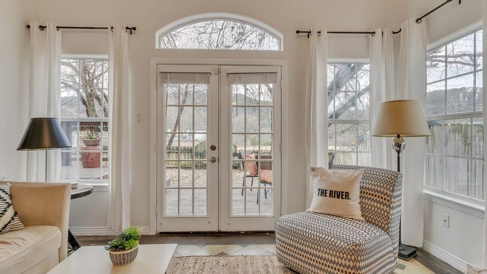 Bright and cheery living area that leads to a backyard deck.
