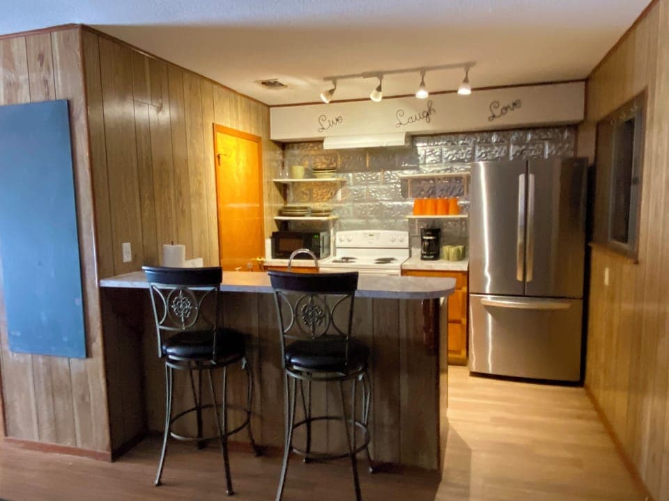 NORTH STAR - THE KITCHEN HAS A BAR, STAINLESS FRIG, PANTRY FOR FOOD STORAGE AND WOOD FLOORS.