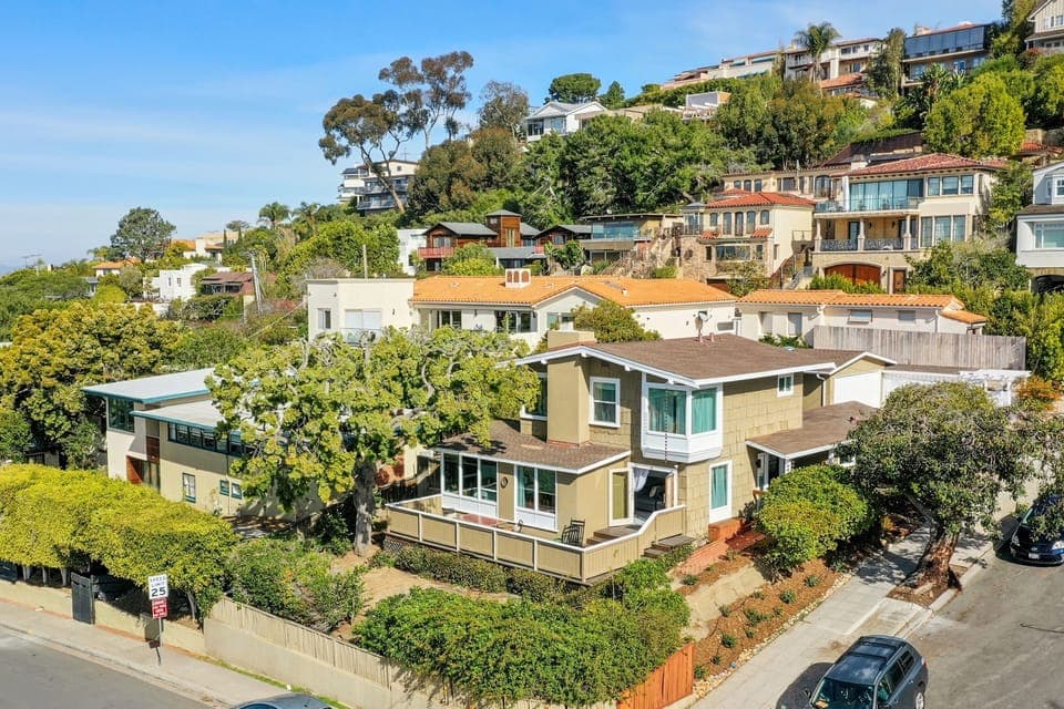 Charming Coastal Retreat with Lush Greenery and Serene Ocean and Hillside Views