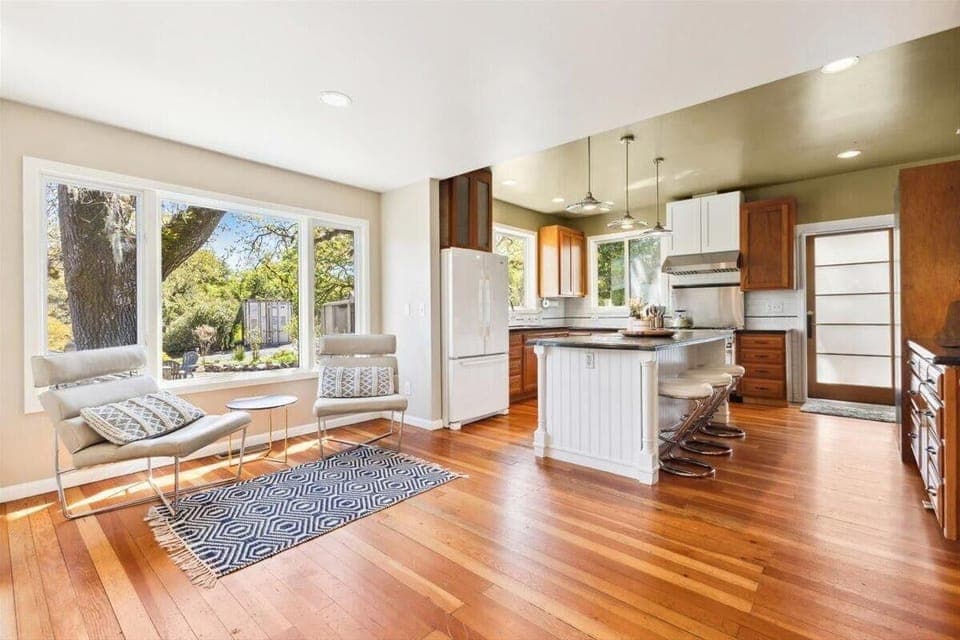 Main House - Sunlit kitchen and cozy living area with garden views