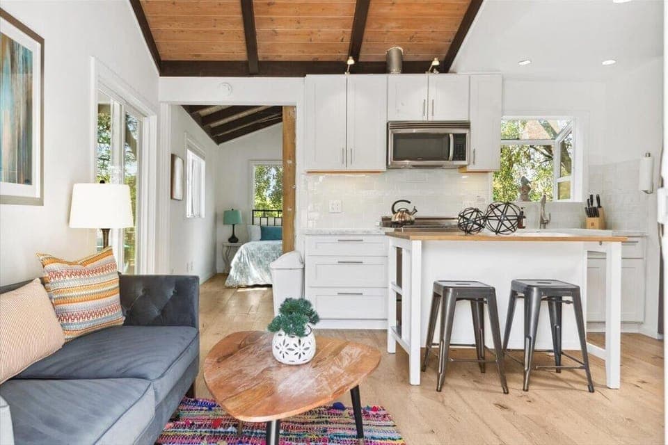 2-Bedroom Unit - Bright, open living room with cozy seating and modern kitchen