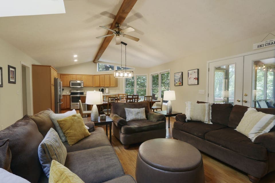 Open floorplan with hardwood floors and cathedral ceilings.