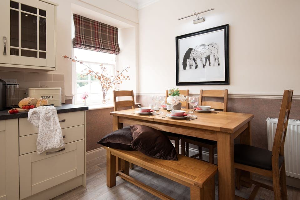 School View - dining space with bench seating and chairs for four