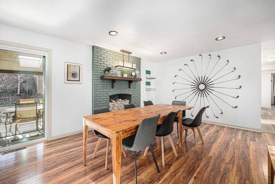 - Dine in style with a reclaimed wood table and striking golf themed wall feature
- Faux brick fireplace nook and modern lighting set a warm, creative atmosphere
- Patio access brings fresh air and outdoor charm right to your mealtime moments