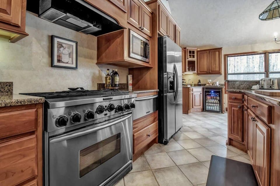 Kitchen with 6 burner stove, warming tray oven and radiant floor heat