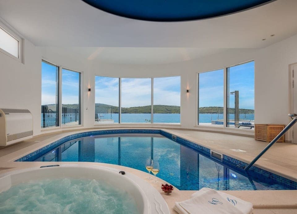 Indoor heated pool and jacuzzi of the luxury beachfront villa for family vacation in Sibenik