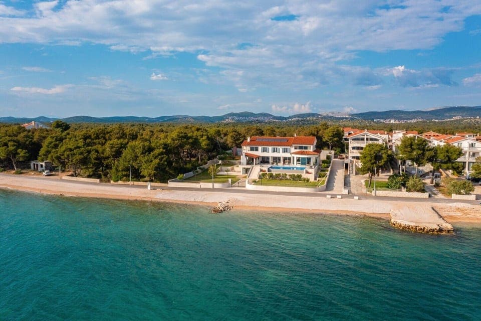 Aerial view of a luxury villa Sea Whisper with private pool, sauna, jacuzzi and gym by the sea in Sibenik