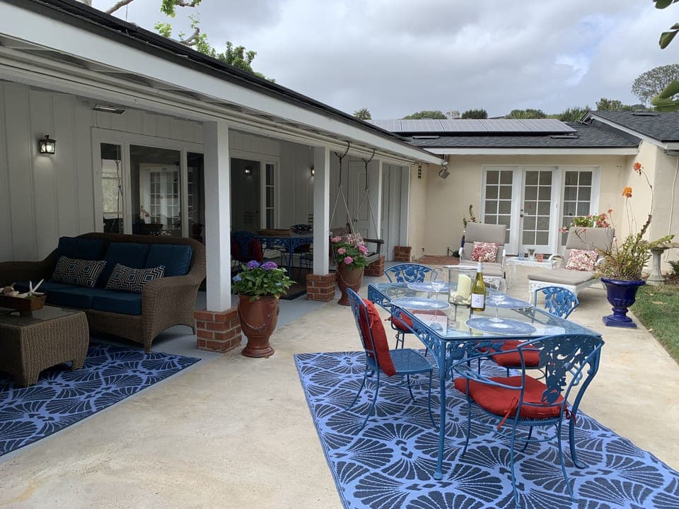 Big back yard with lush landscaping and lots of out door seating