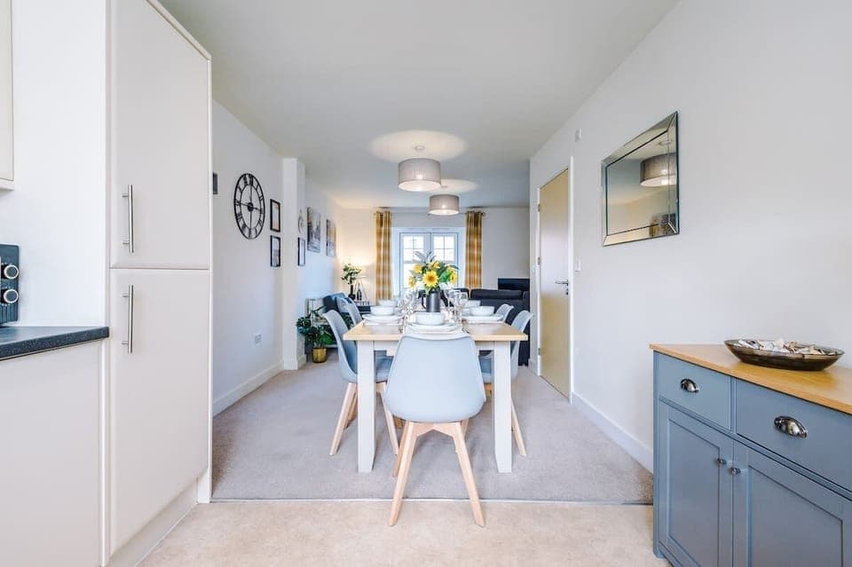 Open plan dining area benefiting from an 8 seater dining table.