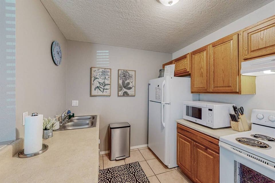 Kitchen includes dishwasher, garbage disposal, stove, microwave, full refrigerator and Keurig with k-cups provided. 
