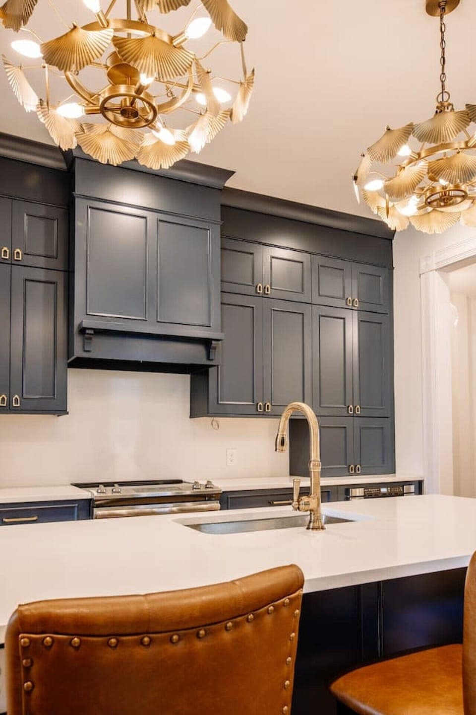 Gourmet Kitchen: Sleek navy cabinetry and stunning gold fixtures for culinary creativity!