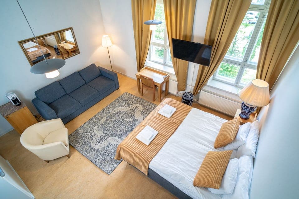 Deluxe Double or Twin Room | Desk, laptop workspace, blackout drapes, iron/ironing board