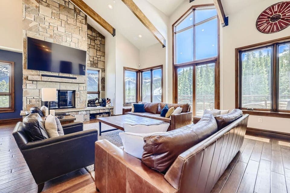 Luxurious ski-in/ski-out lodge with panoramic views, 6 spacious bedrooms, and a home theater. Perfect for large groups, offering high-end amenities including a commercial kitchen, hot tub, and ski room.