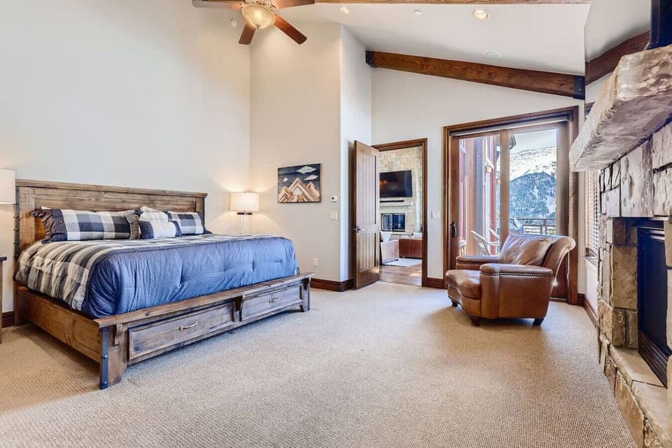 Luxurious master bedroom with a king-sized bed, fireplace, and private access to outdoor views, creating the ultimate comfort and tranquility.