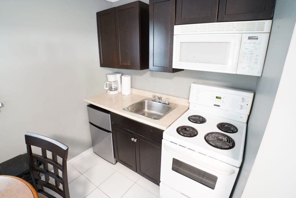 Family Two-Bedroom Suite | Private kitchen | Fridge, microwave