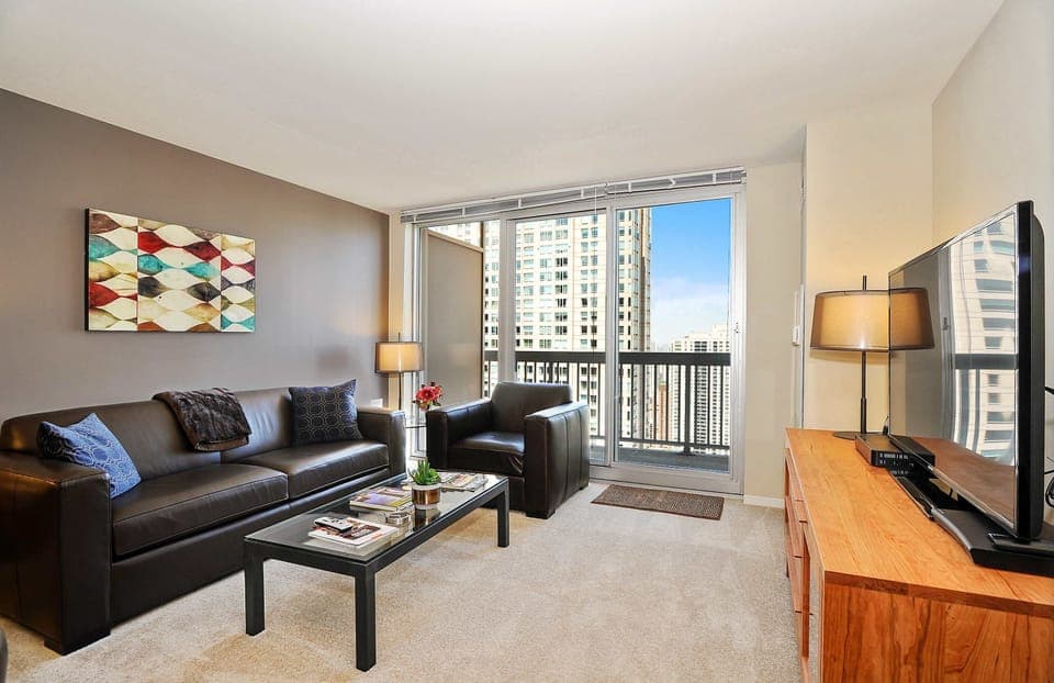 Living Room with queen sleeper sofa and balcony