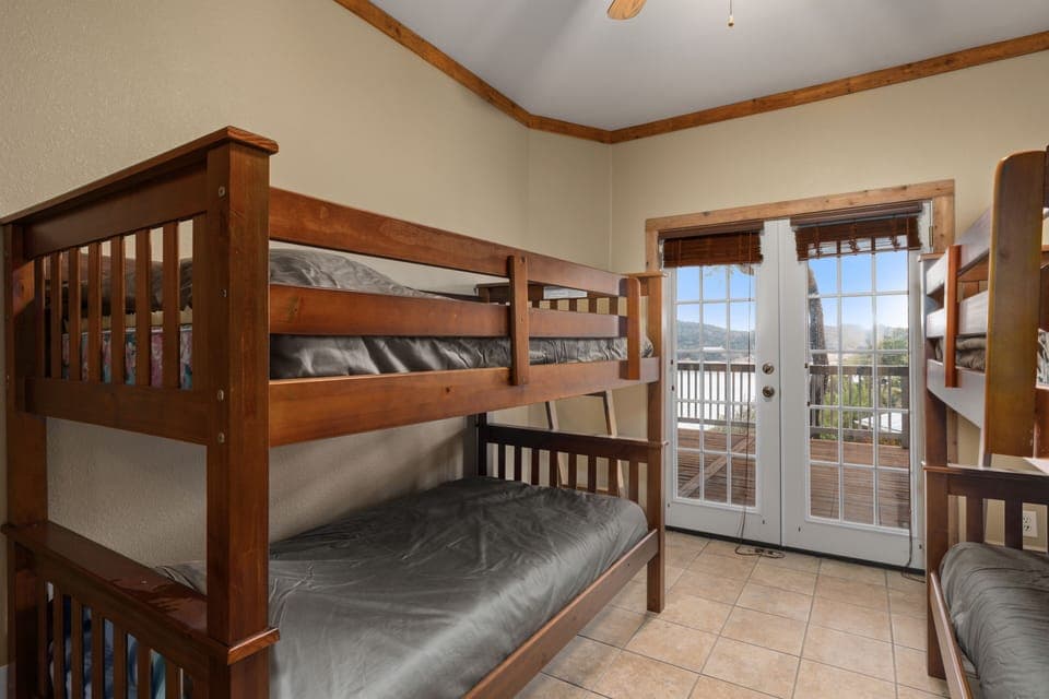 Lower level bunk room. French doors to large deck. Stunning views. Ceiling fan.