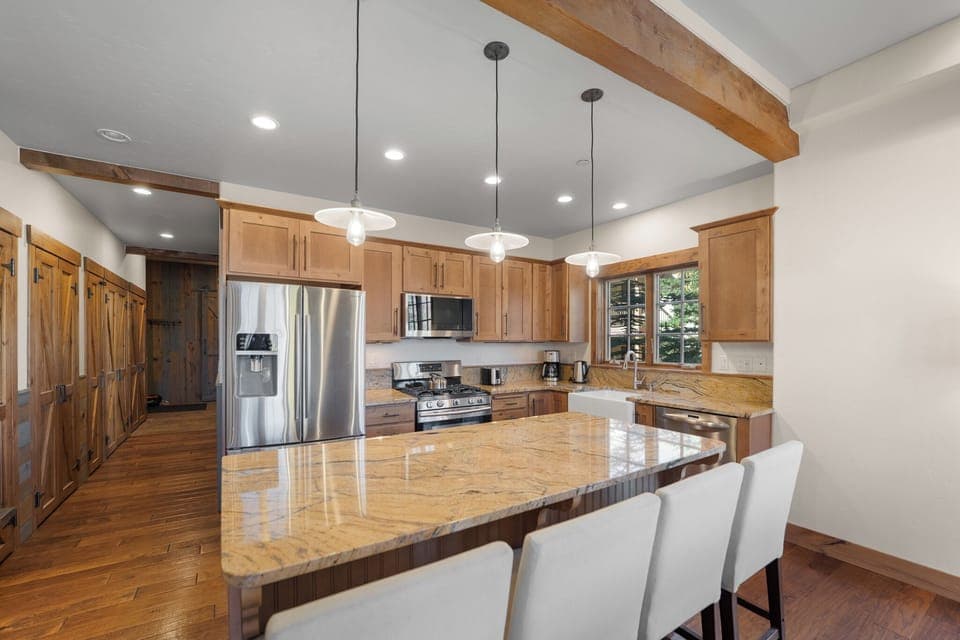 Modern full size kitchen offering granite countertops, beautiful cabinetry, and stainless steel appliances throughout.