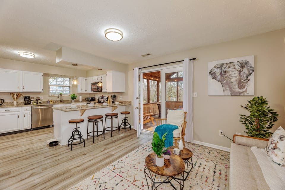 A smaller living room opens up to the kitchen and screened-in porch.
