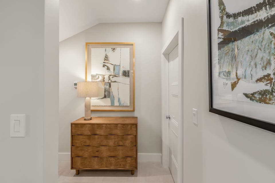 Hall to primary suite with laundry area