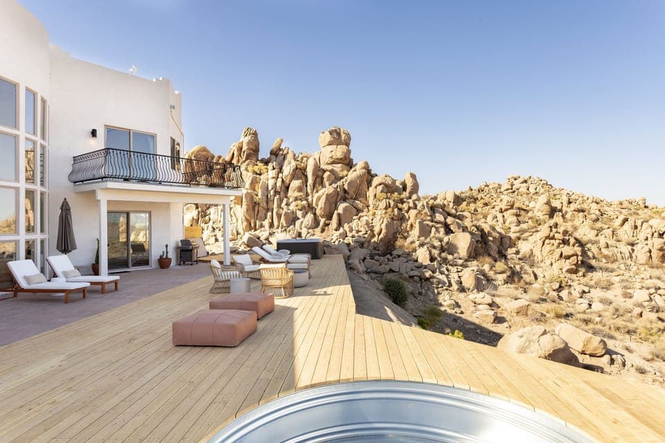 Relaxing private deck with a view of the desert and boulders.