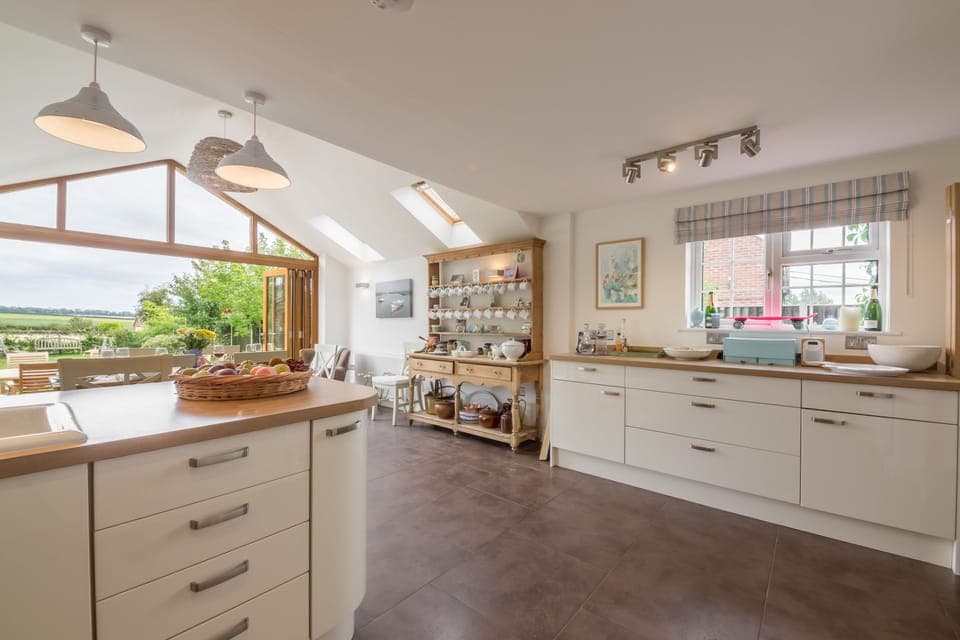 The Potting Shed and Bothy, Ringstead: Spacious kitchen with dining area and bi-fold doors to the garden