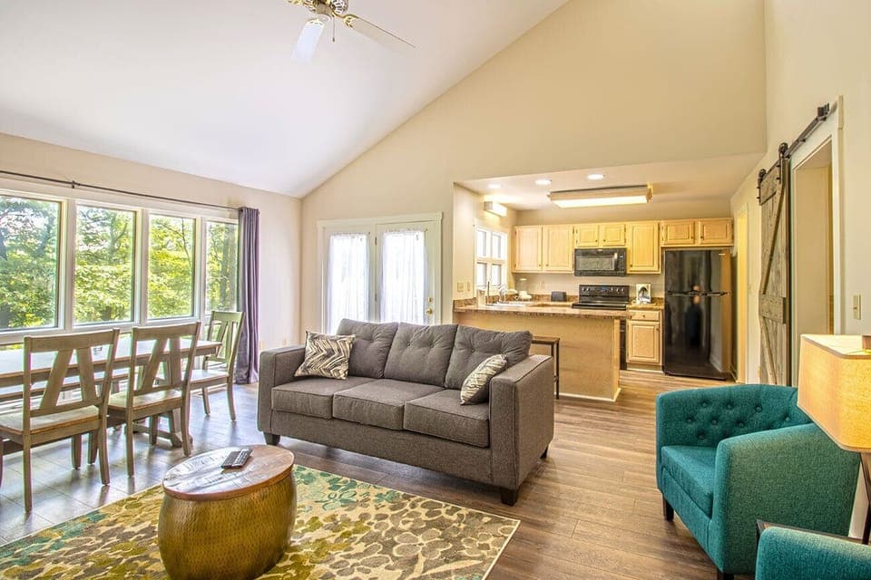 Upper level open floor plan includes living area, full kitchen, and dining area