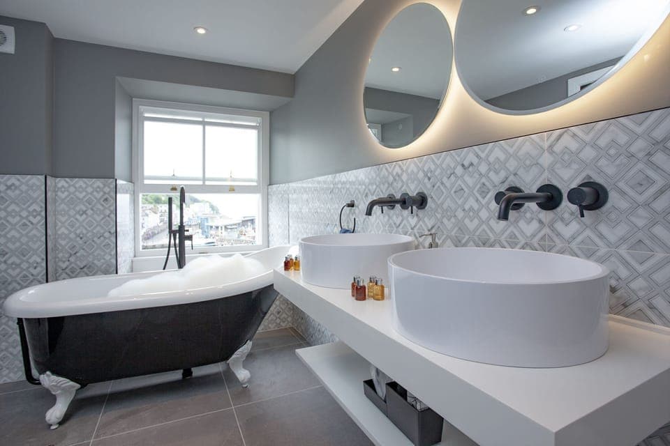 Modern bathroom with freestanding bath and twin basins - Vigilance Suite