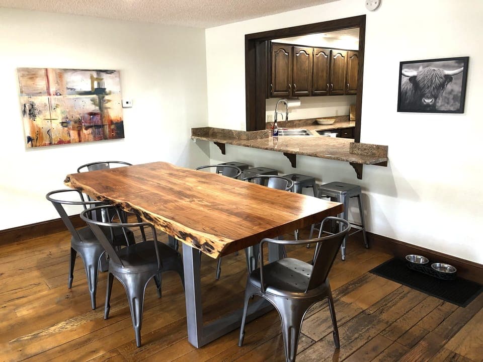 The dining area seats 6-8 at the table, with additional seating at the counter