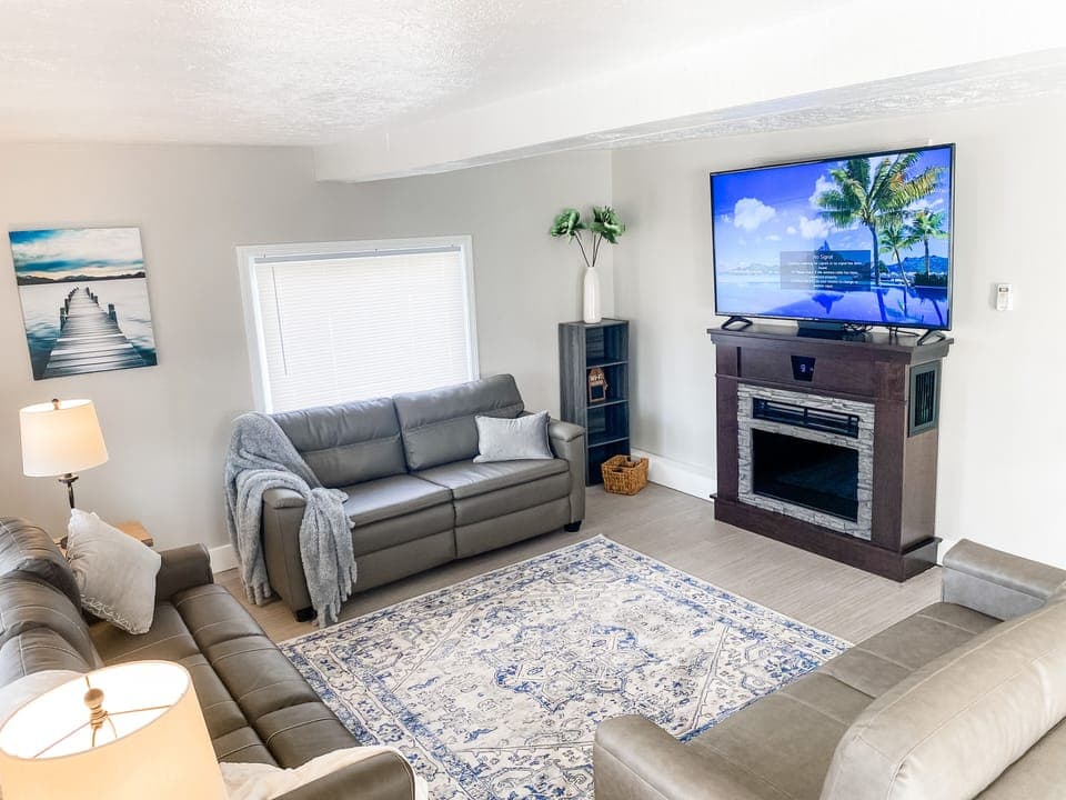 Living Room with fireplace and 65 inch TV
