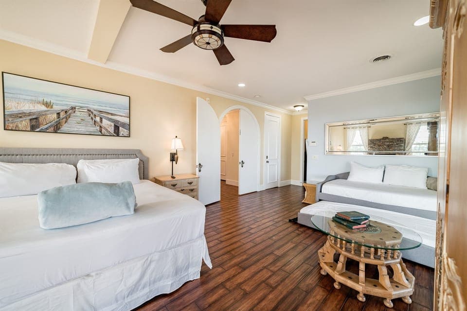 King bedroom with bathroom, TV, fireplace, and sleeper sofa