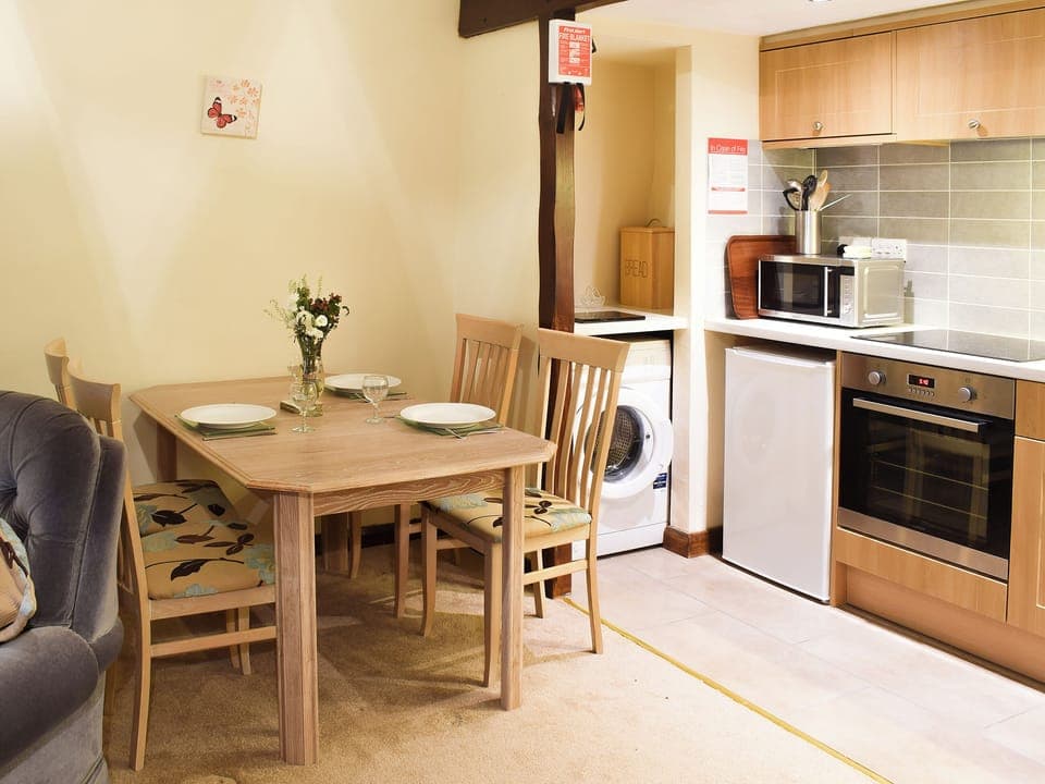 Modest dining area and adjacent kitchen | Willow Cottage - Round Hill Farm, Kirkstone near Ambleside