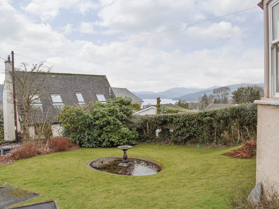 Lawned front garden with extensive views over the lake to the mountains beyond | 1 Brantfield House, near Bowness on Windermere