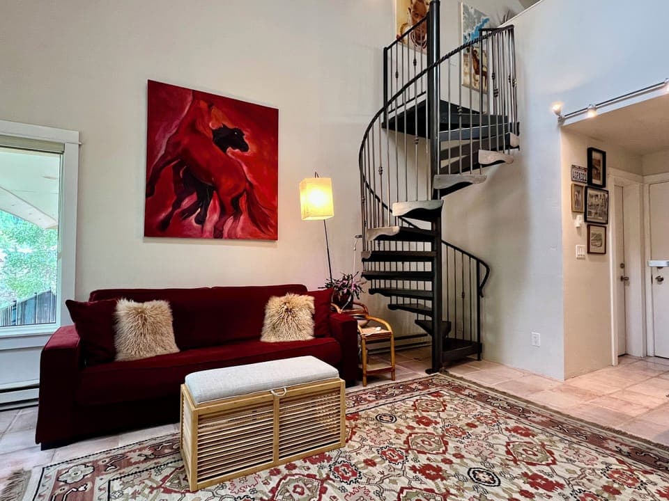Large living room with soaring vaulted ceilings and bright natural lighting.