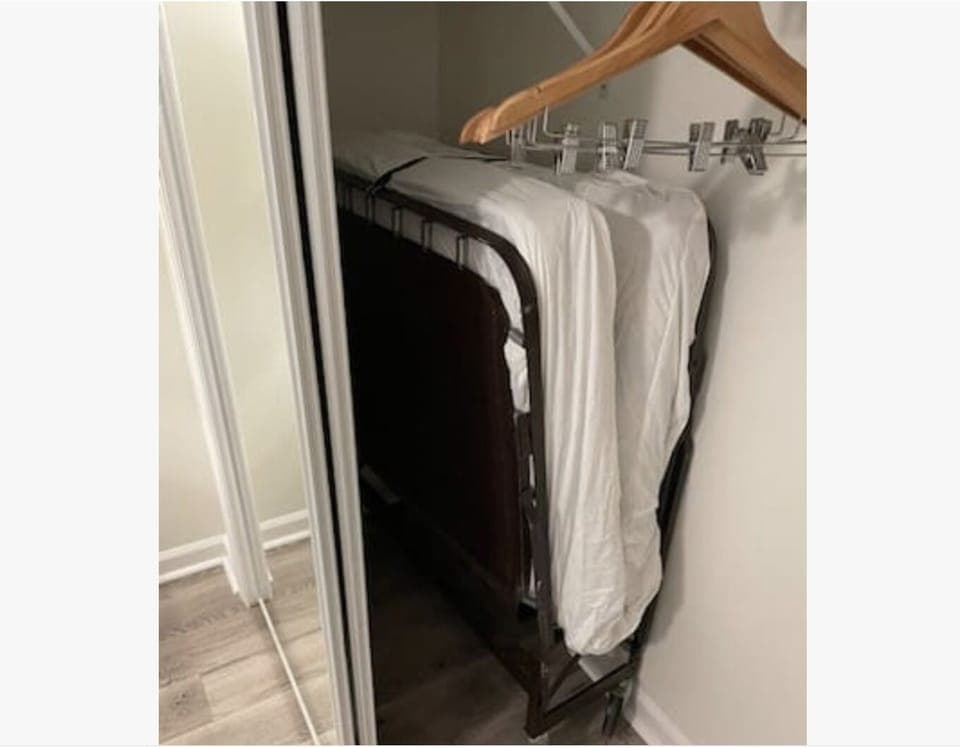 Extra rollaway twin bed stored in the closet of the guest bedroom