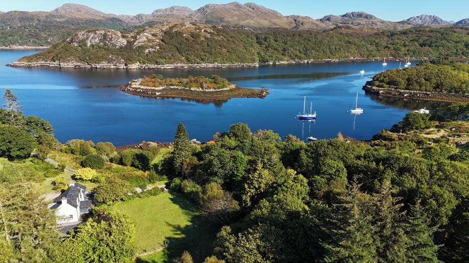 Aerial view showing house, garden and proximity to the sea
