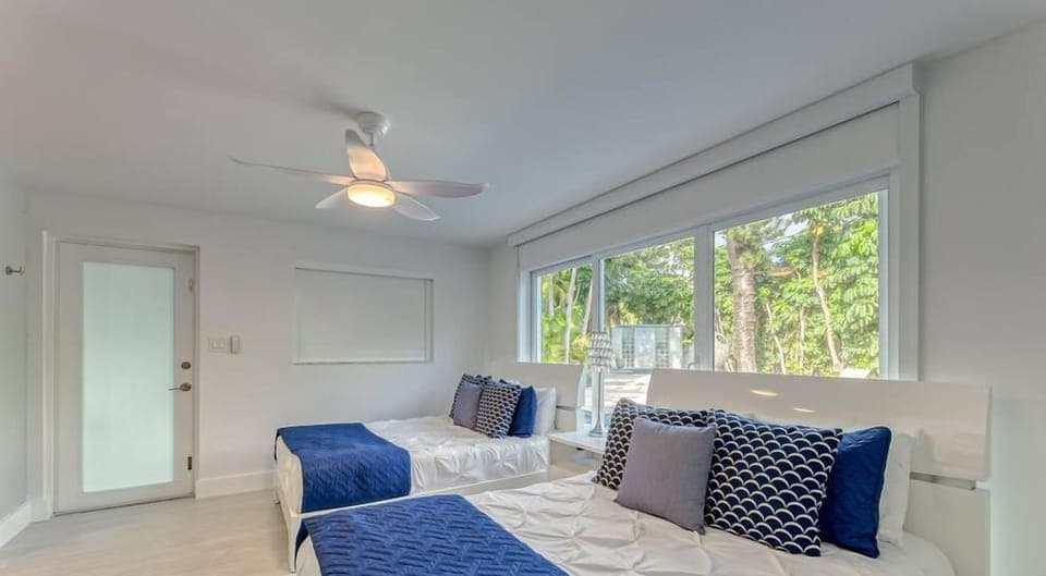 3rd Bedroom (Cabana Room) with 2 Double Beds, En-Suite Bathroom, Smart TV, Blackout Shades & Double doors for wide step free entrance to bedroom. 