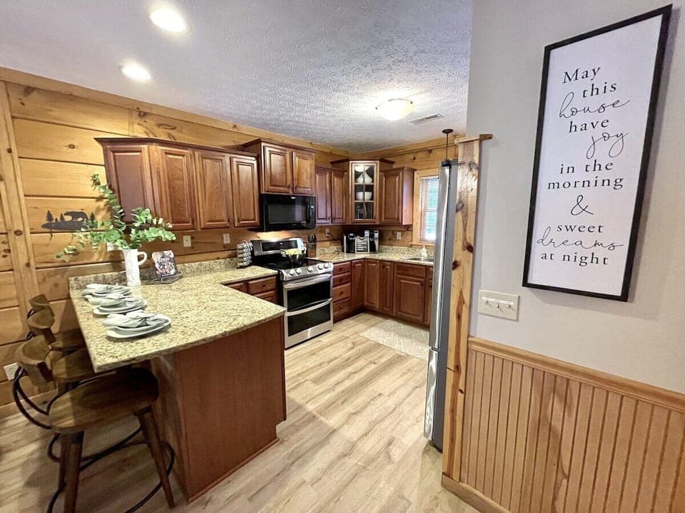 Kitchen area is fully stocked with quality cookware and utensils