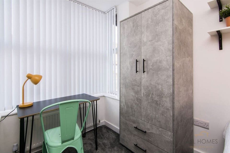 Bedroom 5 is equipped with a wardrobe and work space